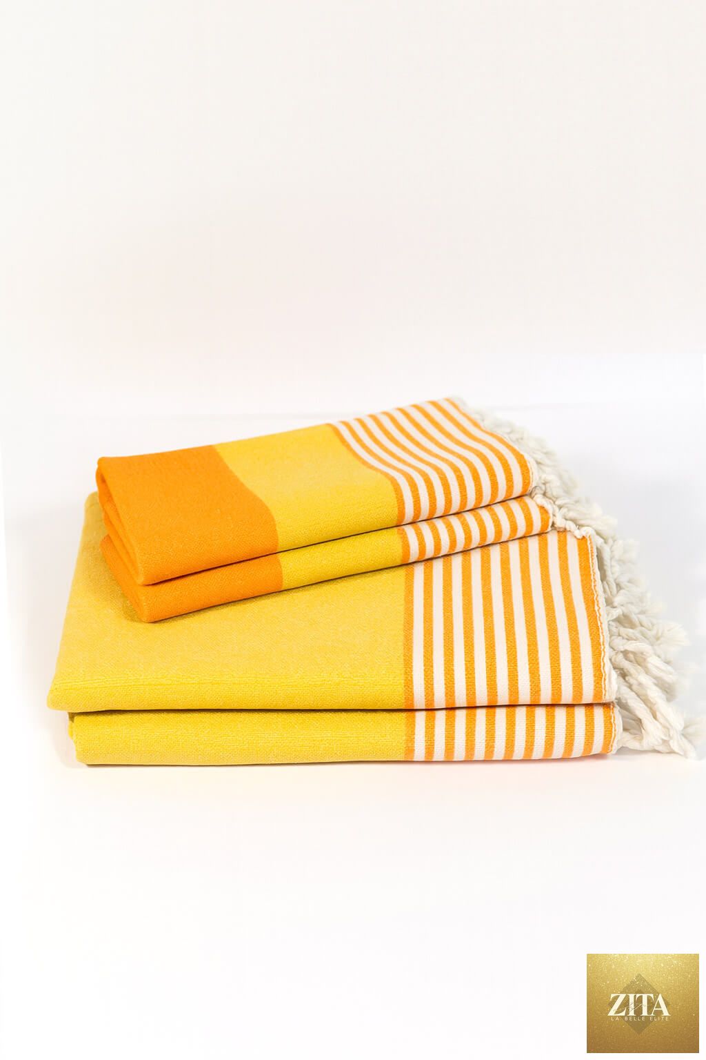 Multi-color Turkish towel bundle by Zita La Belle Elite featuring orange, yellow, and other vibrant woven Turkish towels.