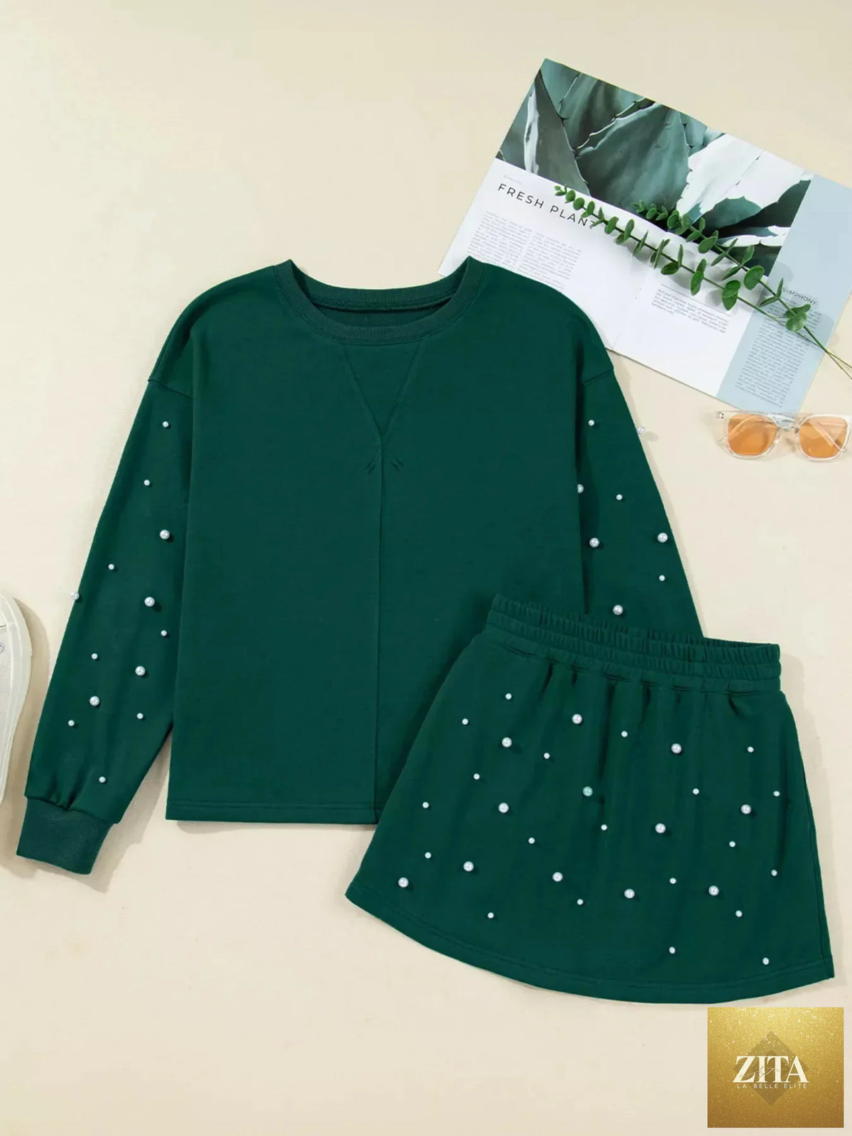 Pearl-embellished drop shoulder pullover and mini skirt set from Wild and Free Boutique, stylish dress with elastic waist and elegant details.
