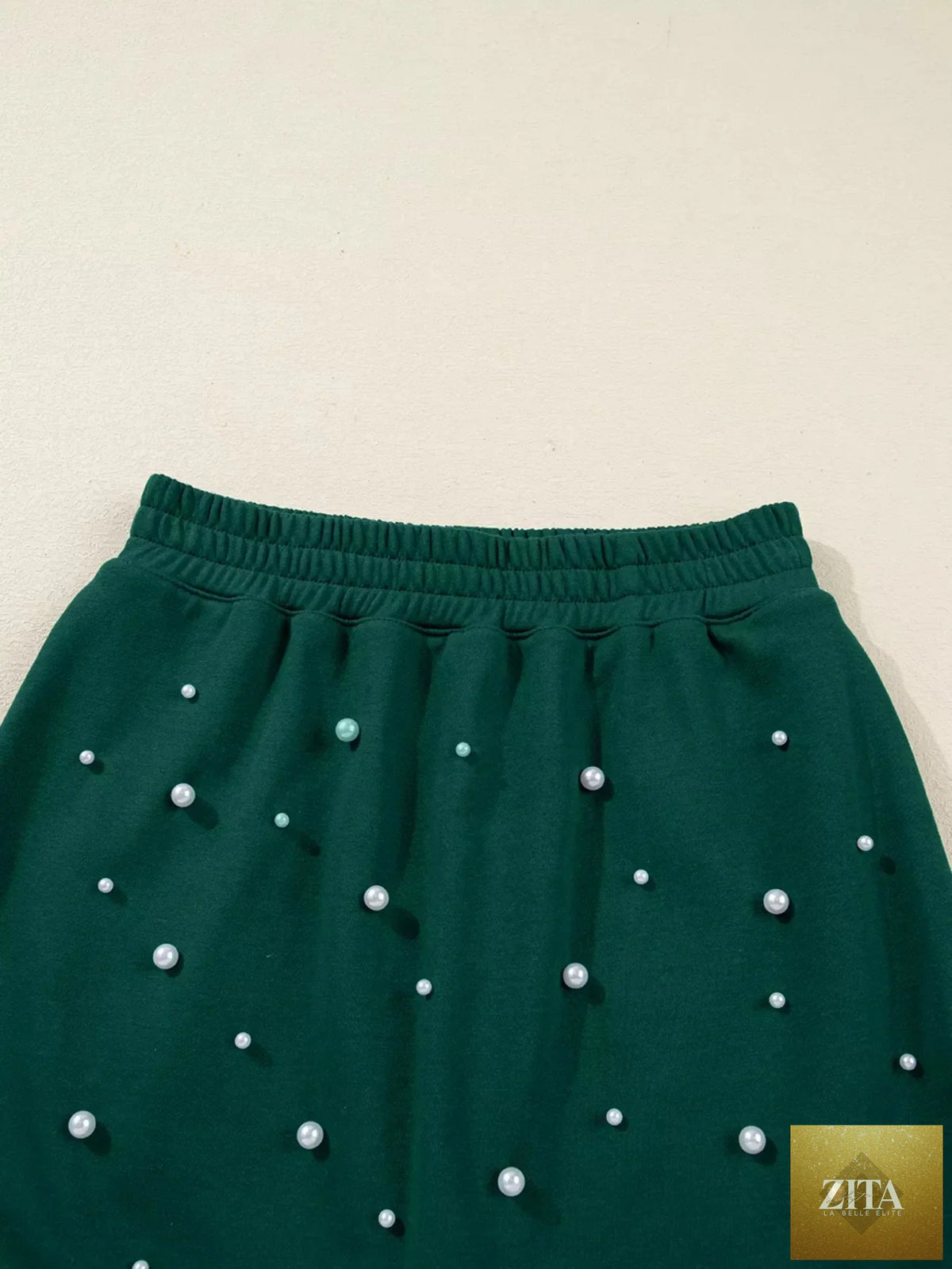 Pearl-embellished drop shoulder pullover and elastic waist mini skirt set by Wild and Free Boutique, stylish and coordinated dress ensemble.