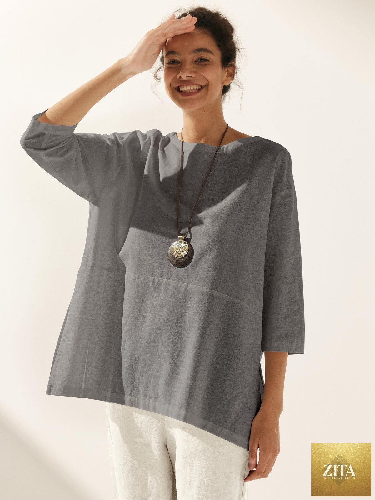 LINTICO Linen White Boat Neck Oversized Top, a relaxed blouse made of linen blend fabric, displayed on a neutral background.