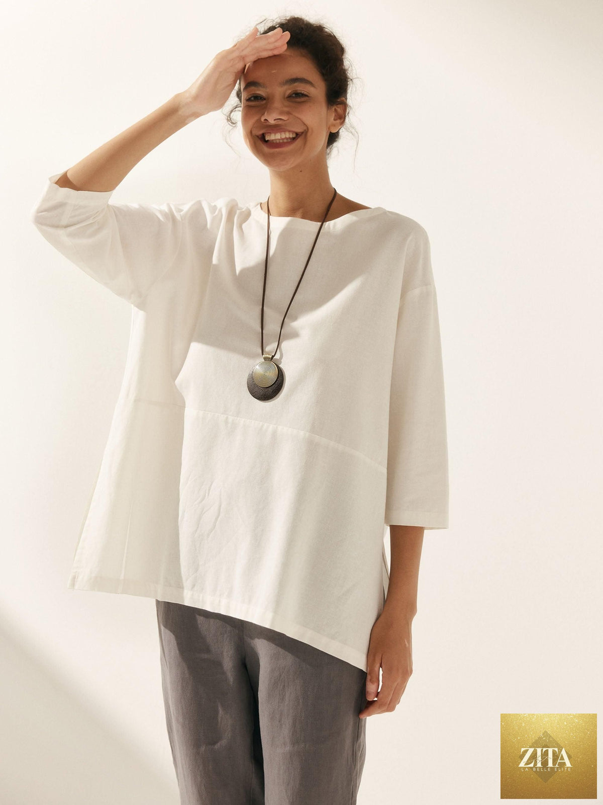 LINTICO Linen white boat neck oversized blouse with relaxed fit, lightweight linen blend fabric, and long sleeves.