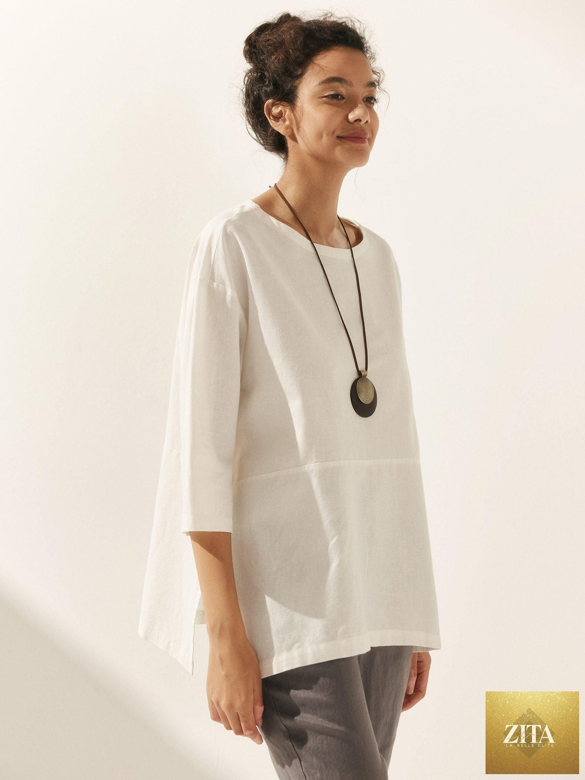 LINTICO linen white boat neck oversized top, a relaxed blouse made from linen blend fabric, displayed on a neutral background.