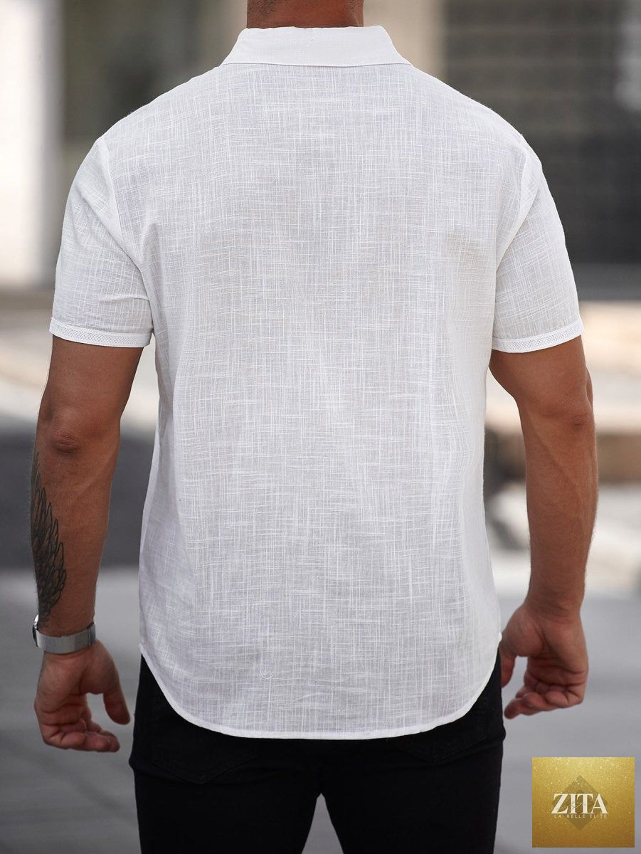 Mandotos men's short-sleeve cotton shirt with front pocket, light fabric and classic fit, shown hanging on a hanger.