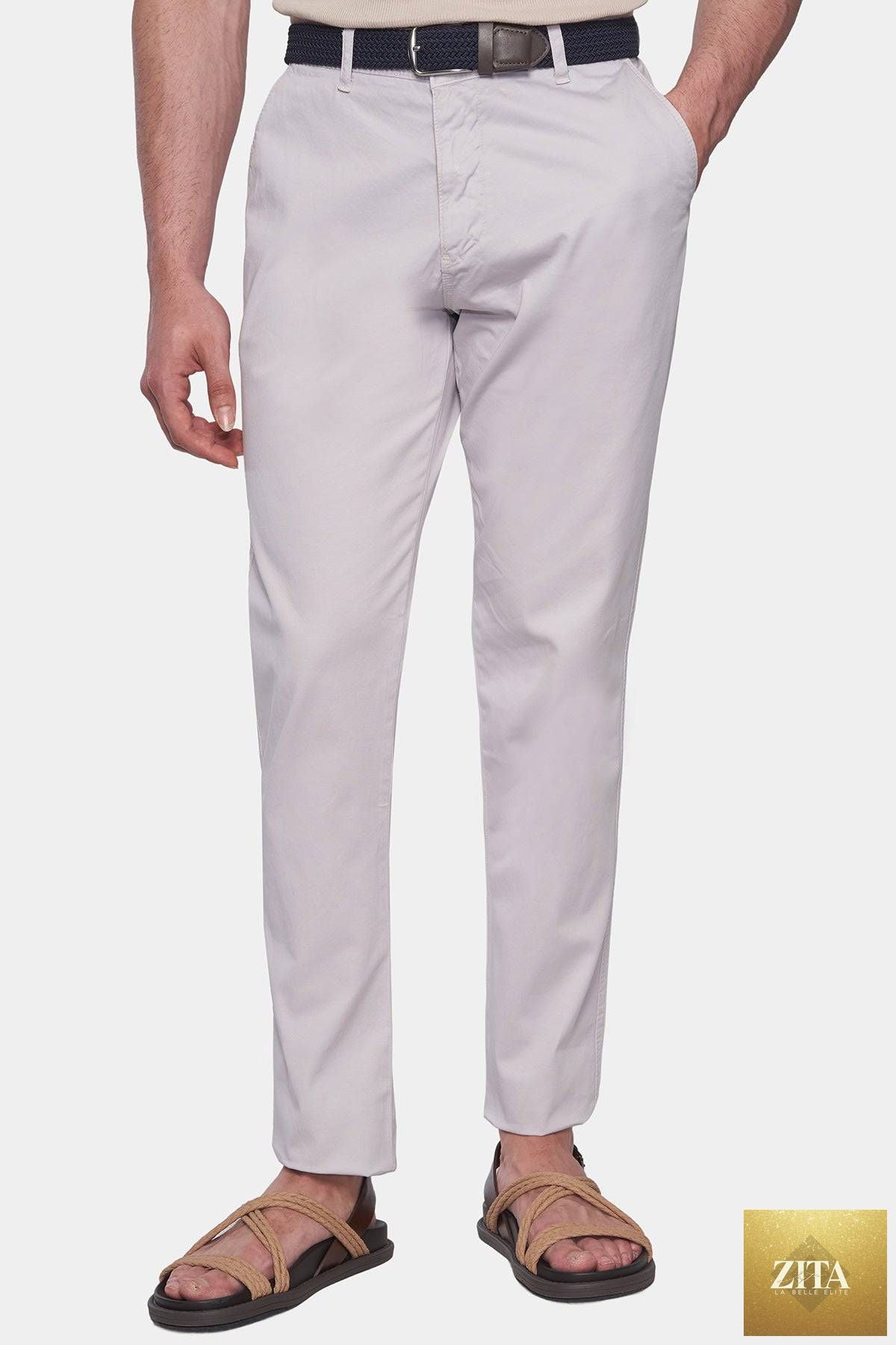 Off-white Bright Moons Timeless Chino pants displayed on a hanger with a focus on the fabric and fit.