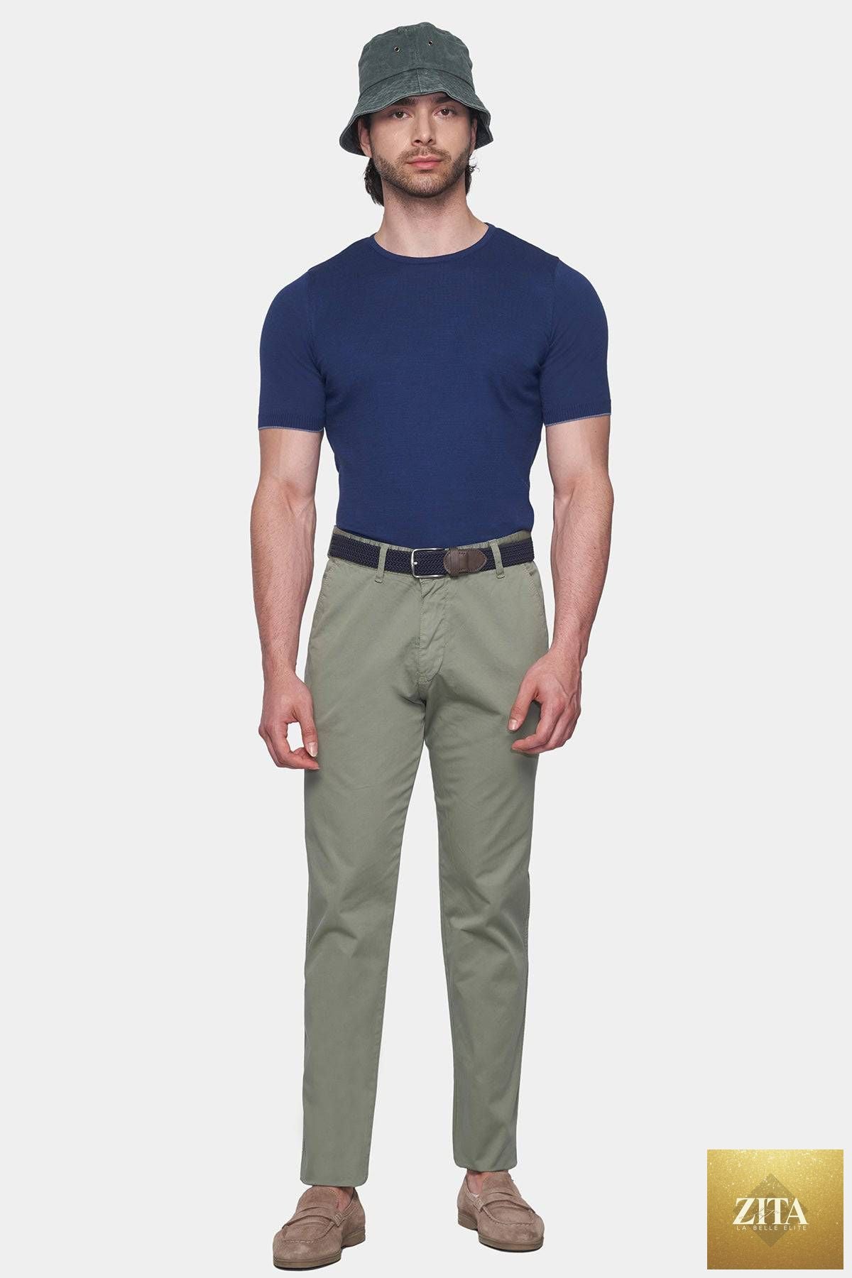 Olive green Bright Moons Timeless Chino pants displayed on a hanger, showcasing classic fit and fabric texture.