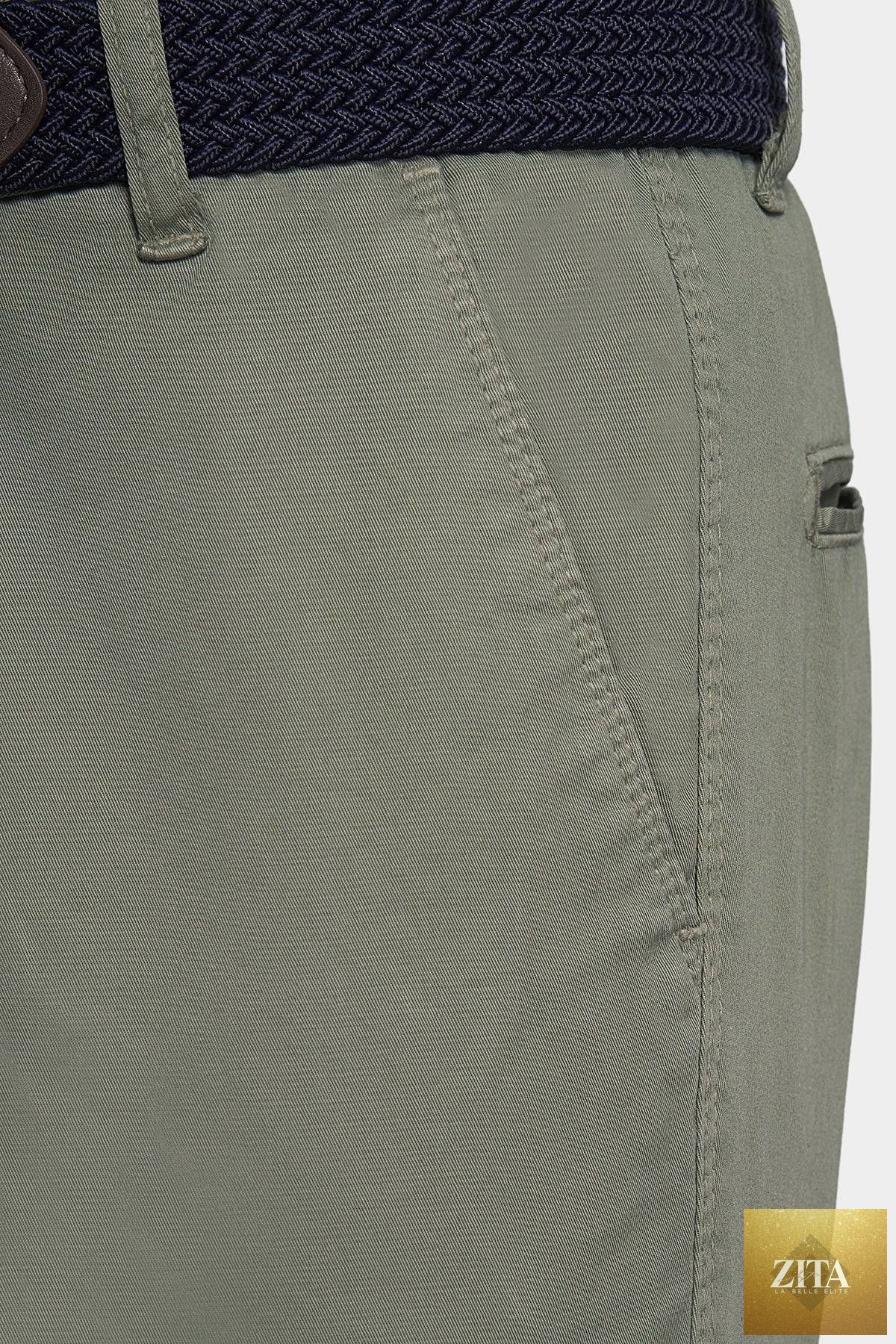 Olive Bright Moons Timeless Chino pants displayed on a hanger, showcasing classic fit and durable fabric for versatile style.