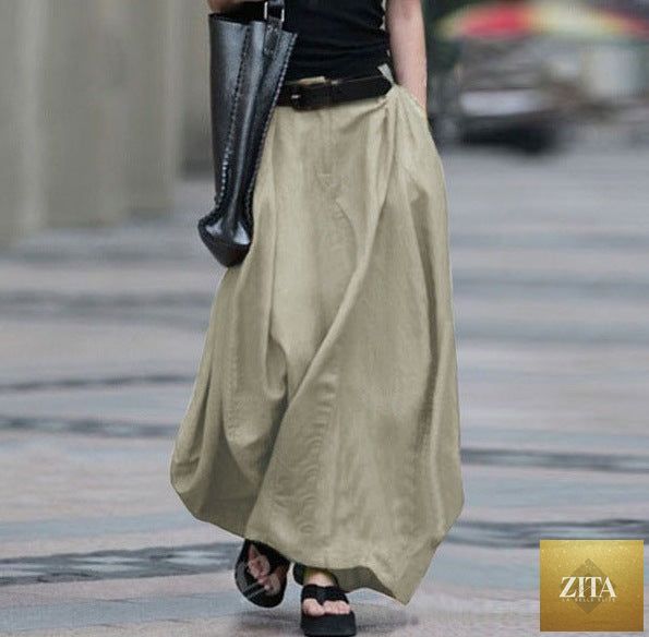 Women's high-waist flared maxi skirt in solid cotton linen with pockets, by FitiqueFit, showcasing its flowy design and comfortable fit.