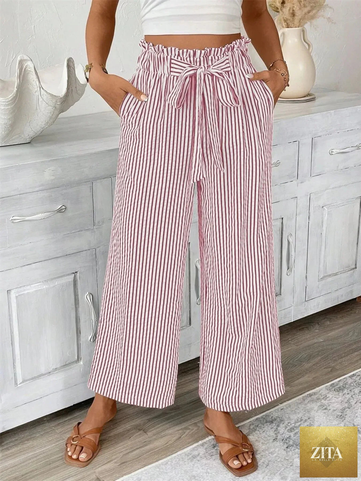 Plus size SITRA striped wide leg paper bag pants with high waist and relaxed fit, featuring bold vertical stripes.