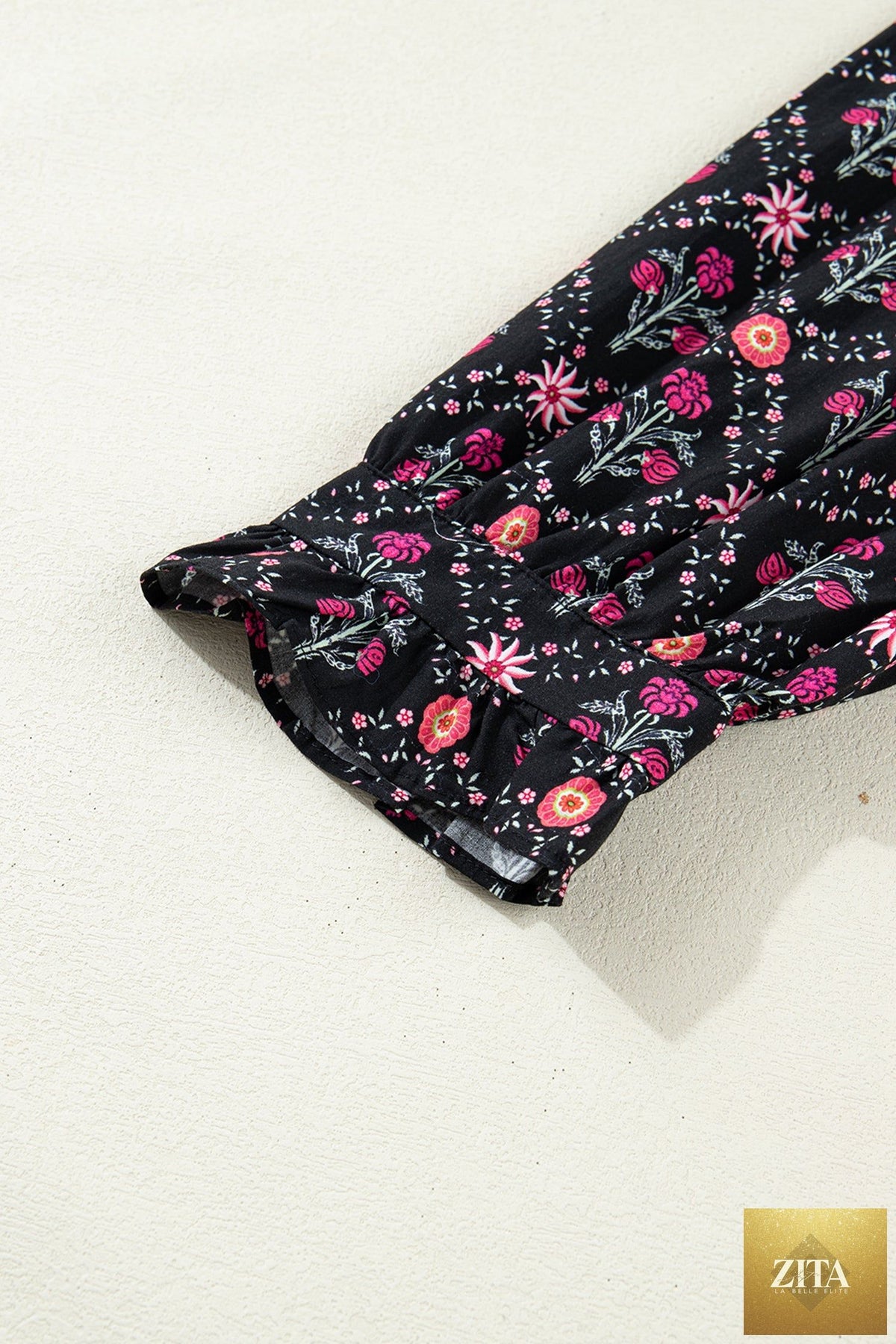 Black floral vintage blouse with contrast V-neckline, bracelet sleeves, and a feminine, stylish design from Wild and Free Boutique.