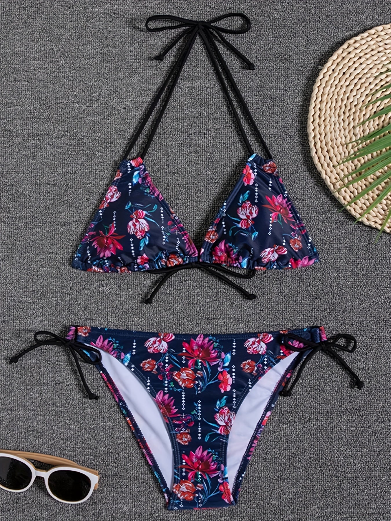 Stevvex Sunset Bloom 2-piece bikini set for women with vibrant floral print, halter neck, tie-back top, and high-cut tie-side bottoms.