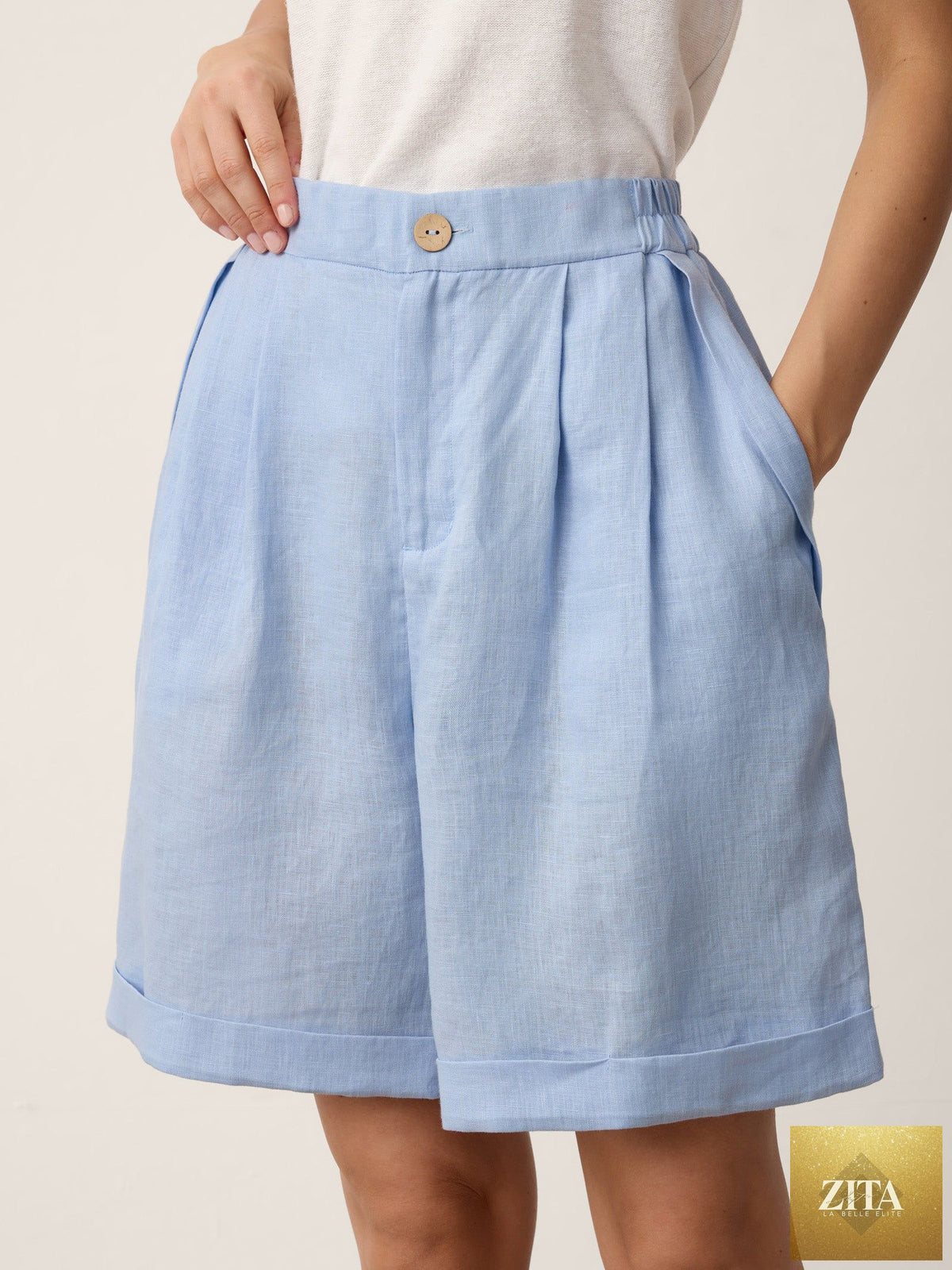 Light azure linen pleated cuffed shorts set from LINTICO, featuring a relaxed fit and comfortable design.