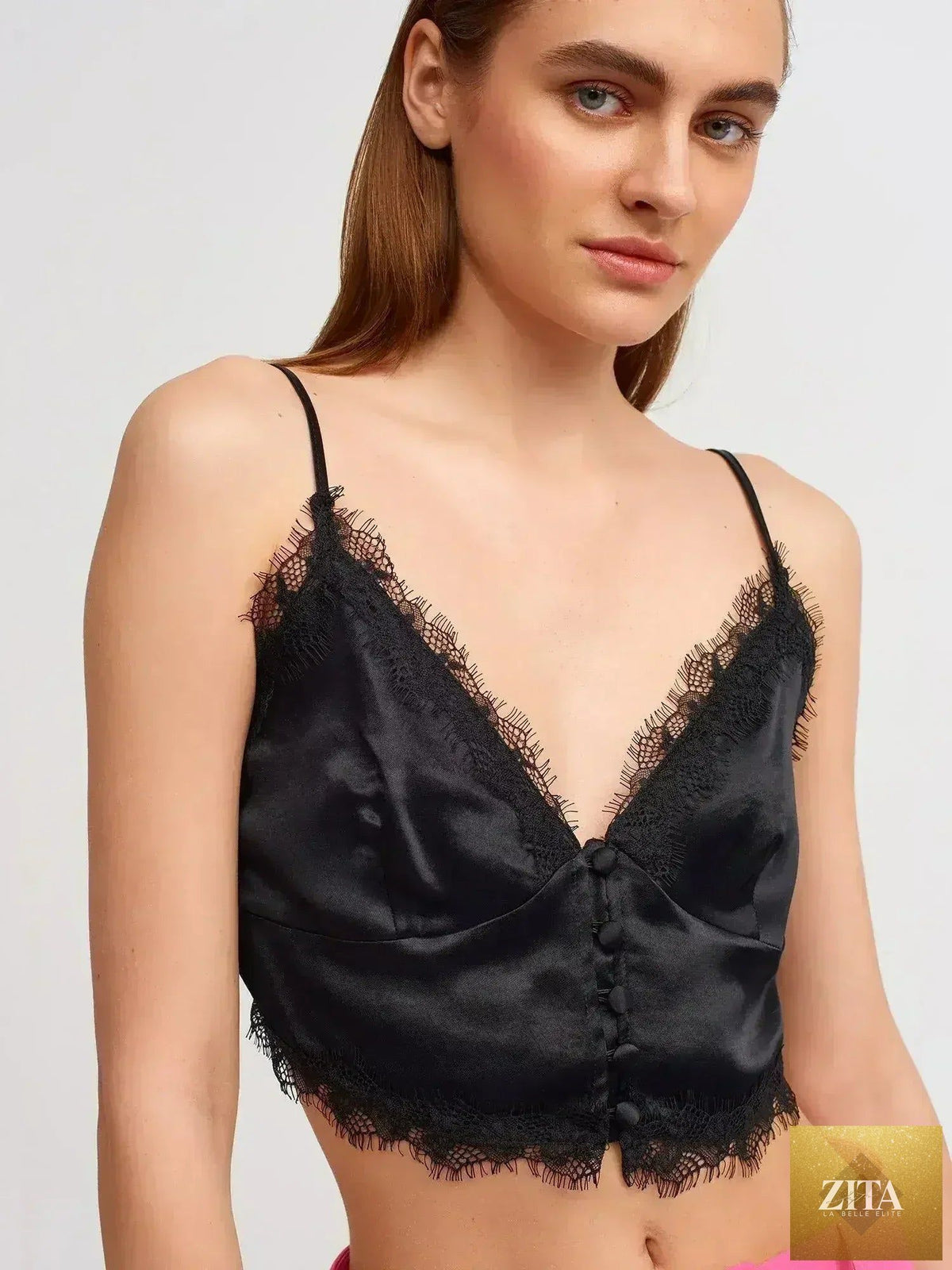 Black lace detail crop top by Femstylo, made from rayon-viscose blend, featuring feminine style and lightweight fabric.