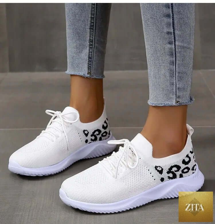 White women's sneakers with leopard print lace-up design by SnagBag, sporty and stylish shoes for women.