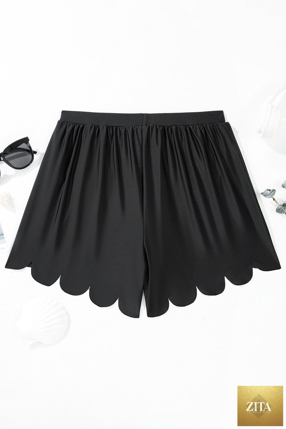 Black scallop trim drawstring beach shorts by Wild and Free Boutique, featuring lightweight fabric and adjustable waist.