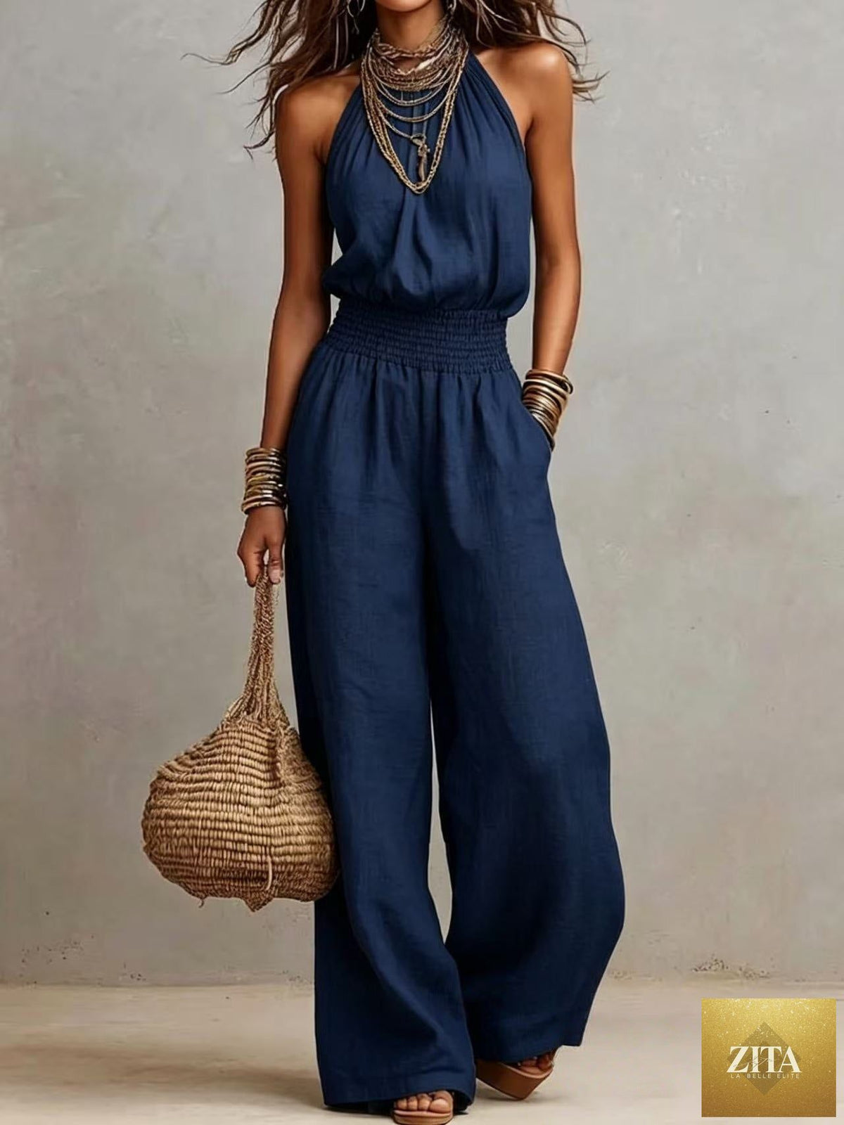 Women's solid color halter-neck backless wide-leg jumpsuit by FitiqueFit, featuring a stylish streetwear look and flowing wide-leg design.