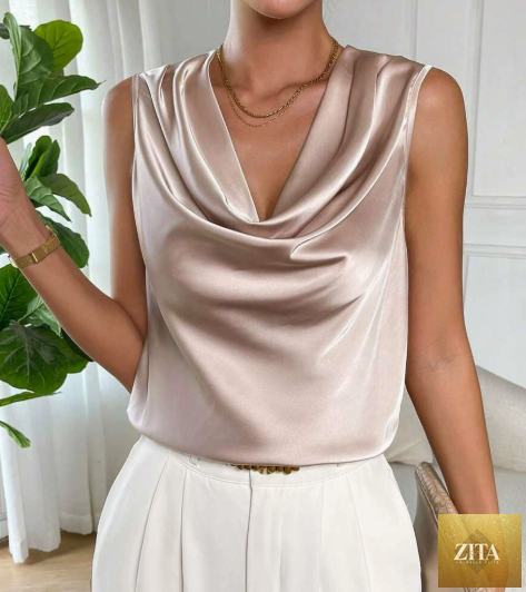 Women’s satin sleeveless shirt from Wanita Store featuring pleated design and embellishments, perfect for spring and summer wear.