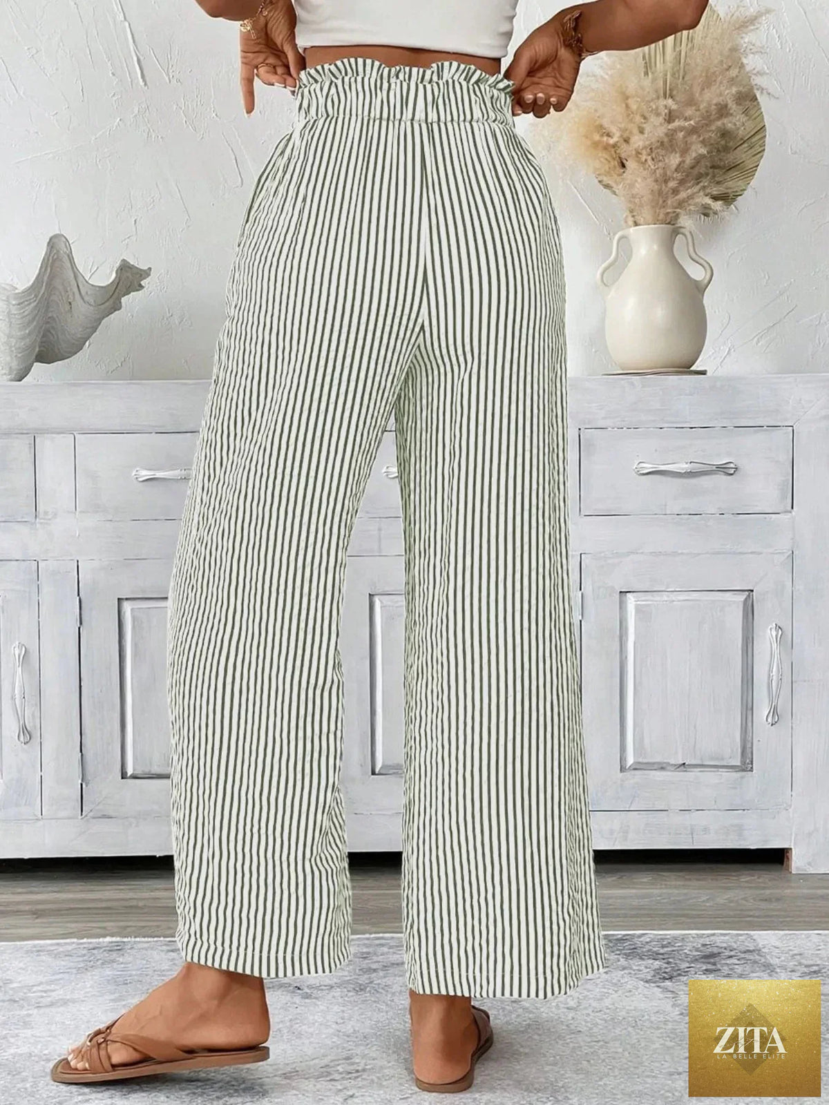 Plus size striped wide leg paper bag pants by SITRA featuring high waist and relaxed fit with bold vertical stripes.