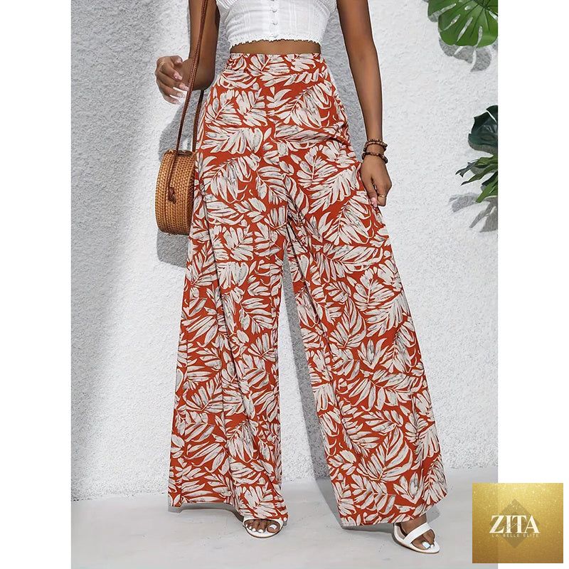 Women’s printed high-waist wide-leg palazzo pants by FitiqueFit, casualwear, featuring a colorful floral print and flowing wide-leg design.