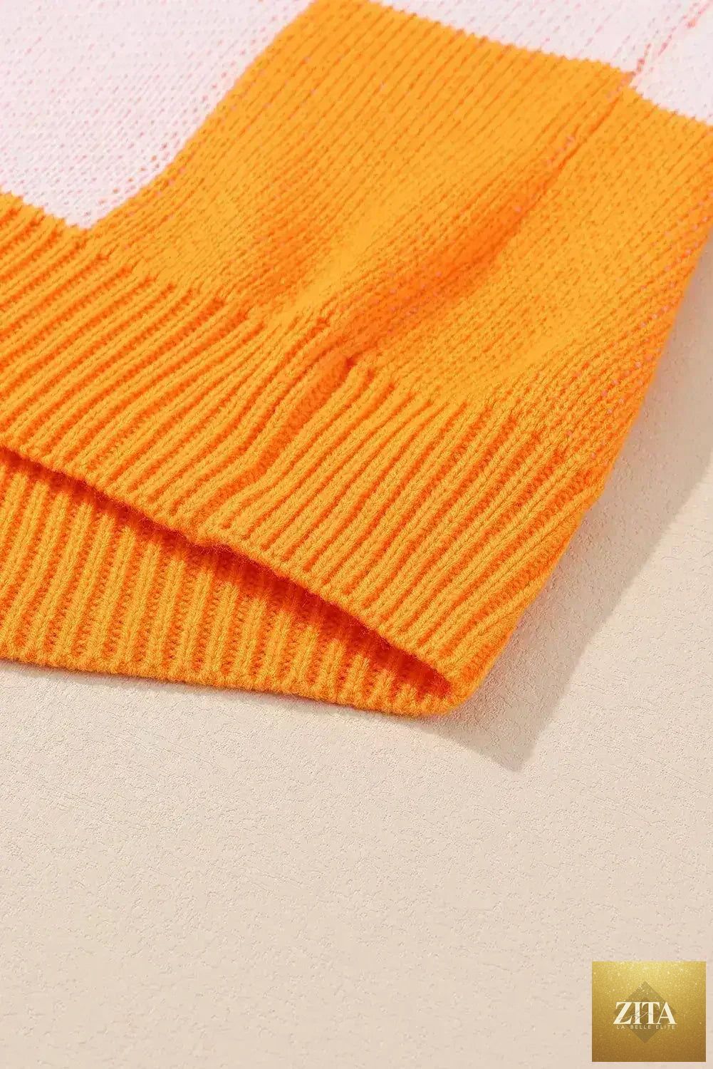 Orange checkered Femstylo bishop sleeve sweater with a cozy knit and stylish pattern, perfect for casual or layered looks.