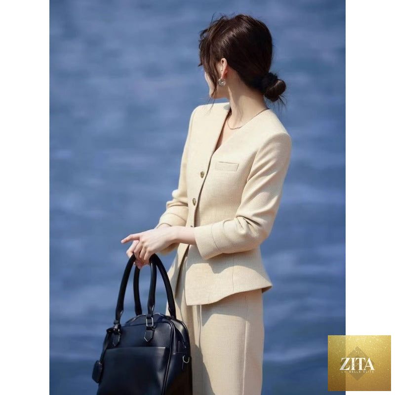 Beige coat and wide-leg pants set by FitiqueFit, featuring a waist-grabbing design and stylish, flowing fabric.