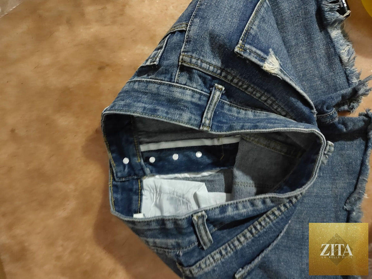 Women’s ripped tassel denim shorts with distressed details and frayed hems, perfect for summer casual wear.