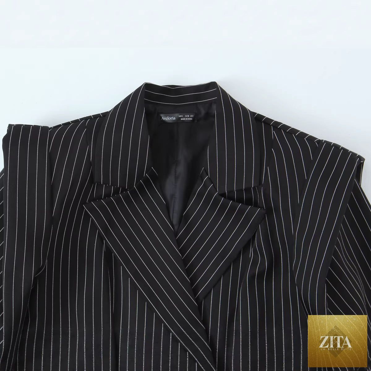 Women’s striped wide-shoulder blazer by Sell My Stuff, featuring bold horizontal stripes and a tailored fit.