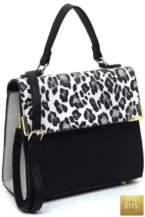 Femstylo vegan leather satchel with top handle and crossbody strap, showcasing its sleek design and smooth texture.