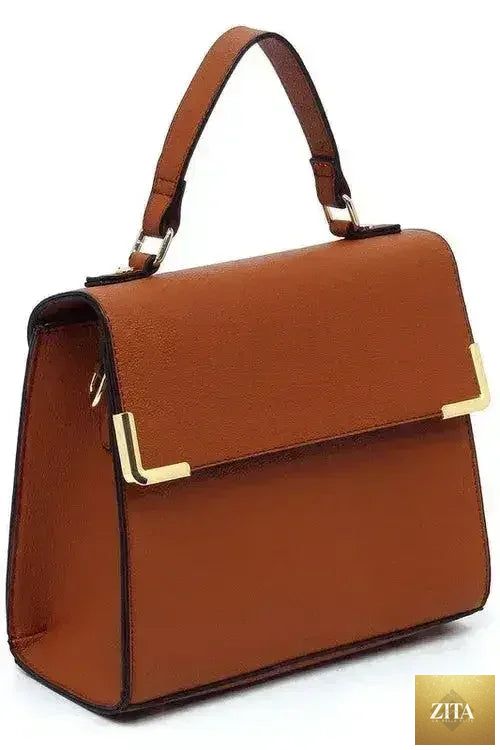 Femstylo vegan leather satchel with top handle and crossbody strap, showcasing its sleek, stylish bag design and textured surface.