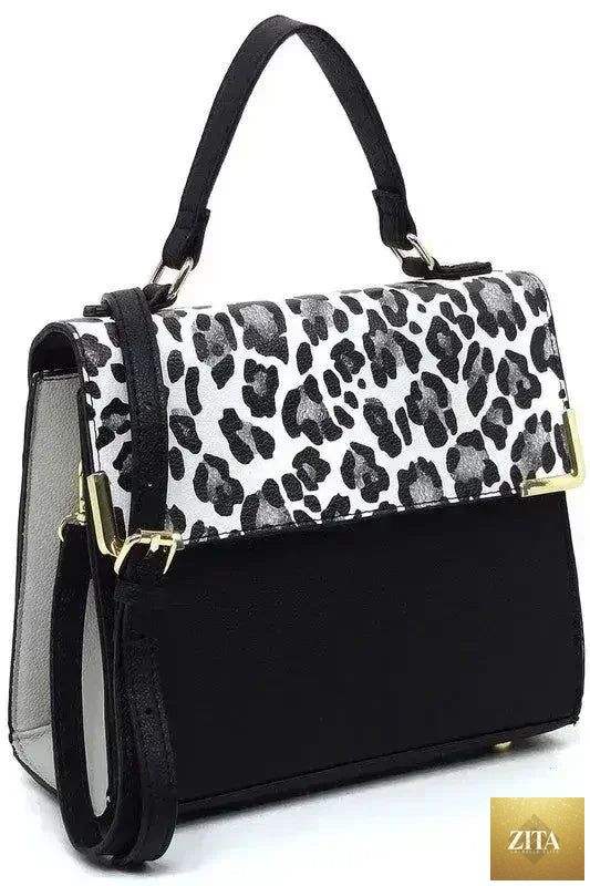 Vegan leather satchel bag with top handle and crossbody strap by Femstylo, showcasing its sleek design and textured surface.