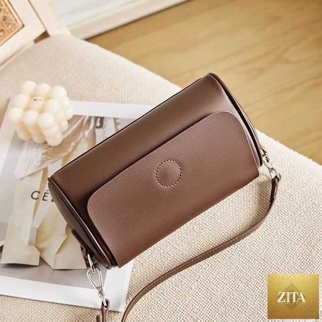 Elegant genuine leather mini round handbag tote for women with shoulder strap, stylish and compact for everyday use.
