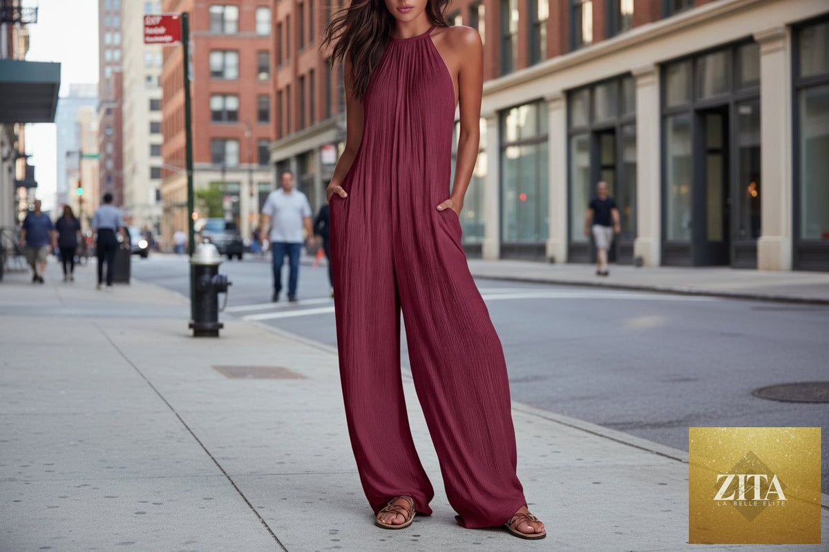 Women's sleeveless open-back wide-leg pleated jumpsuit by Zita La Belle Elite, casualwear, shown from the front on a model.