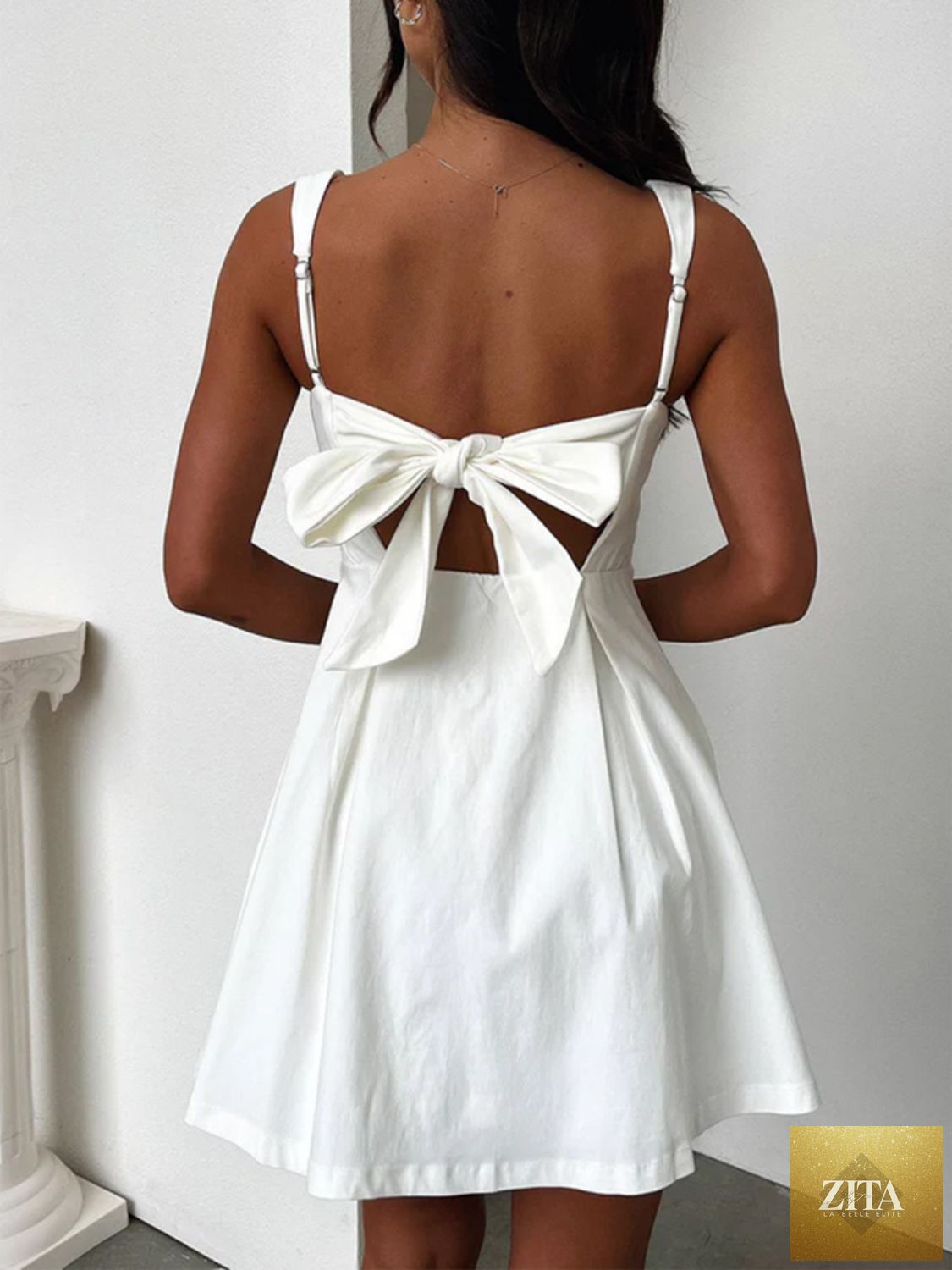 Dark blue Stevvex mini dress with bow back, square neckline, and feminine, flattering silhouette for girls.