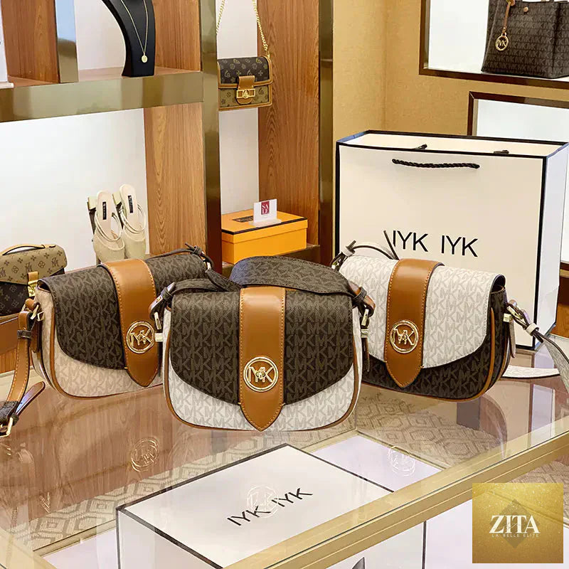 Women's leather saddle bag purse in classic brown with adjustable strap and sleek design, perfect for casual or elegant outfits.