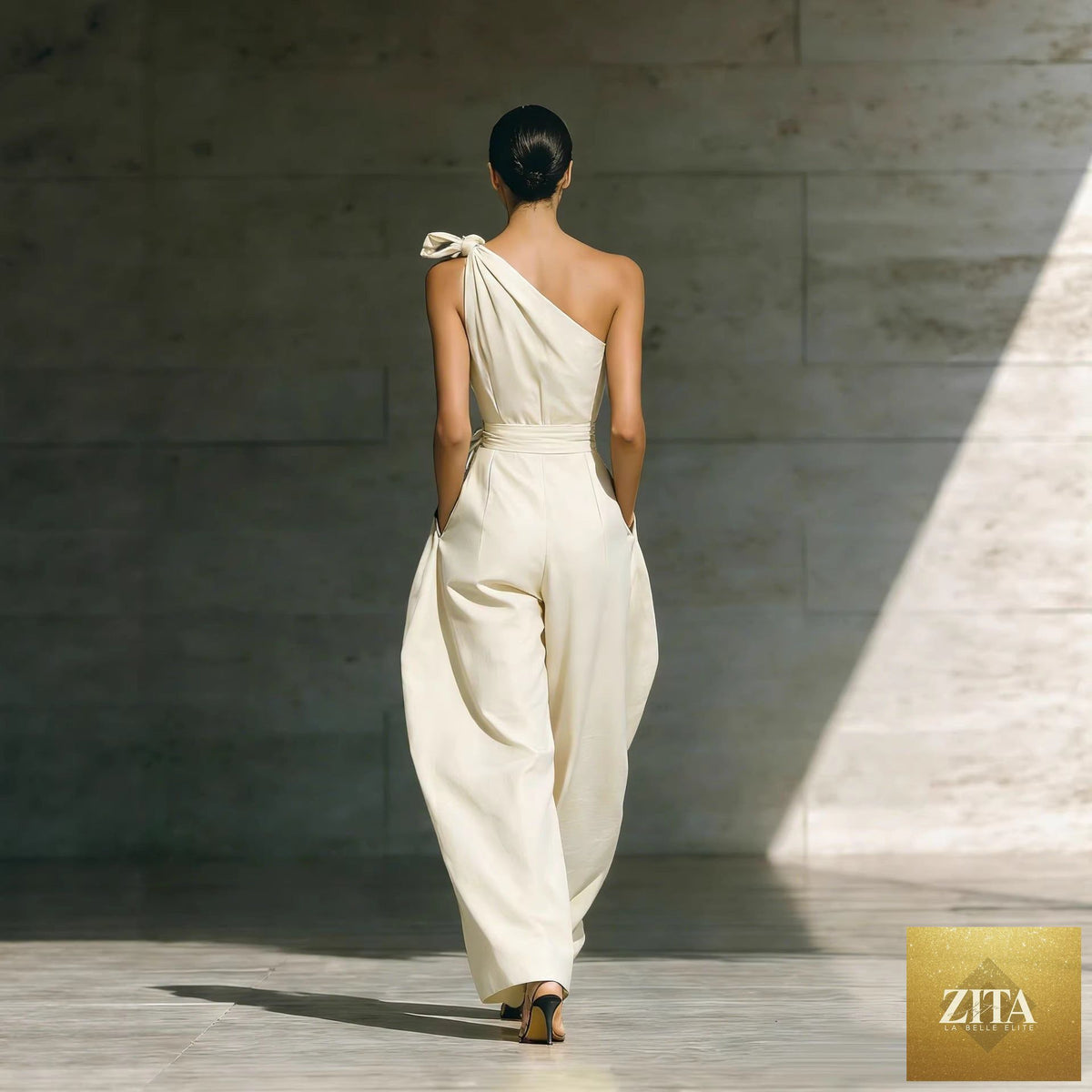 Women's loose sleeveless off-shoulder wide-leg jumpsuit by Zita La Belle Elite, featuring a belt and casualwear style.
