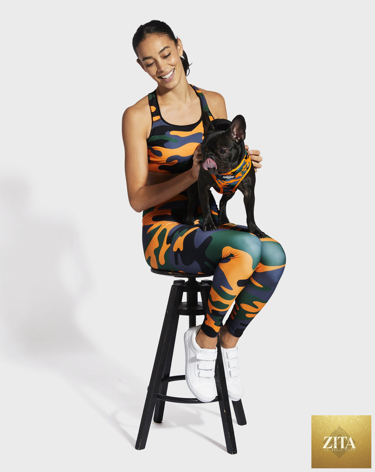 Ruffhaus NYC camo orange sports bra with supportive design, featuring bold camouflage pattern and adjustable straps.