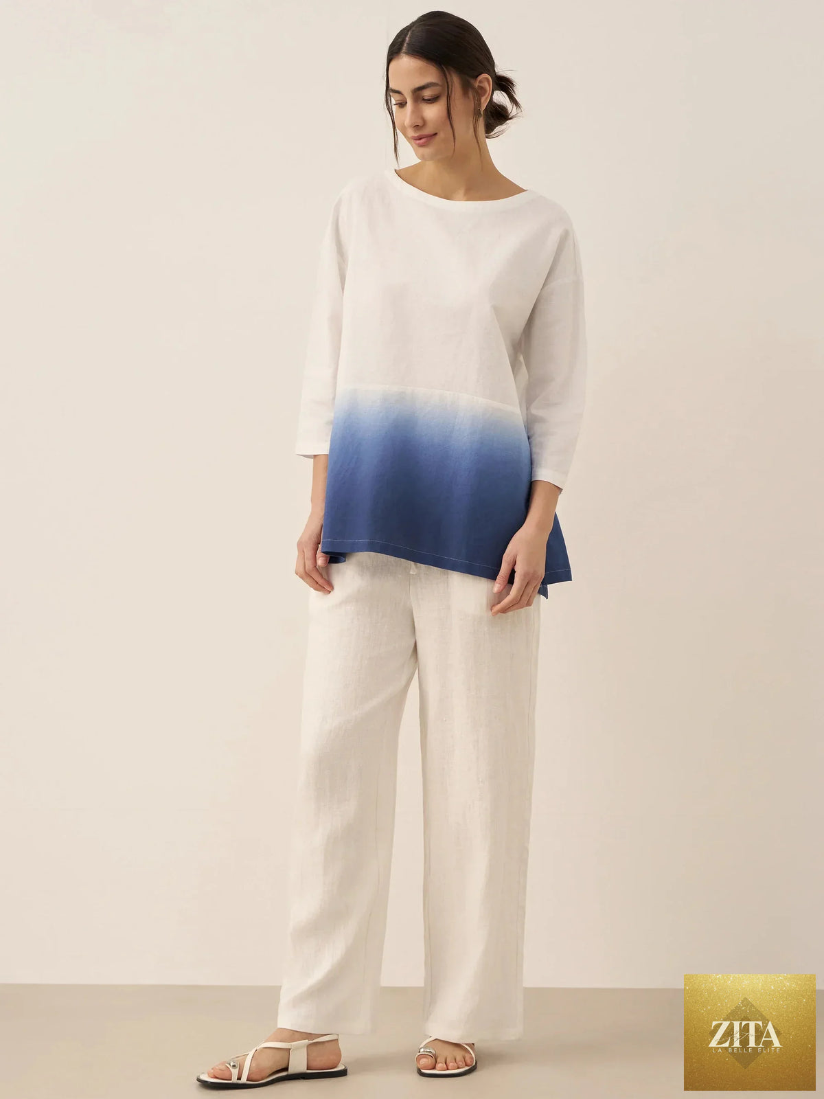 LINTICO linen white boat neck oversized top, blouse-style with relaxed fit, made from linen blend fabric, on a hanger.