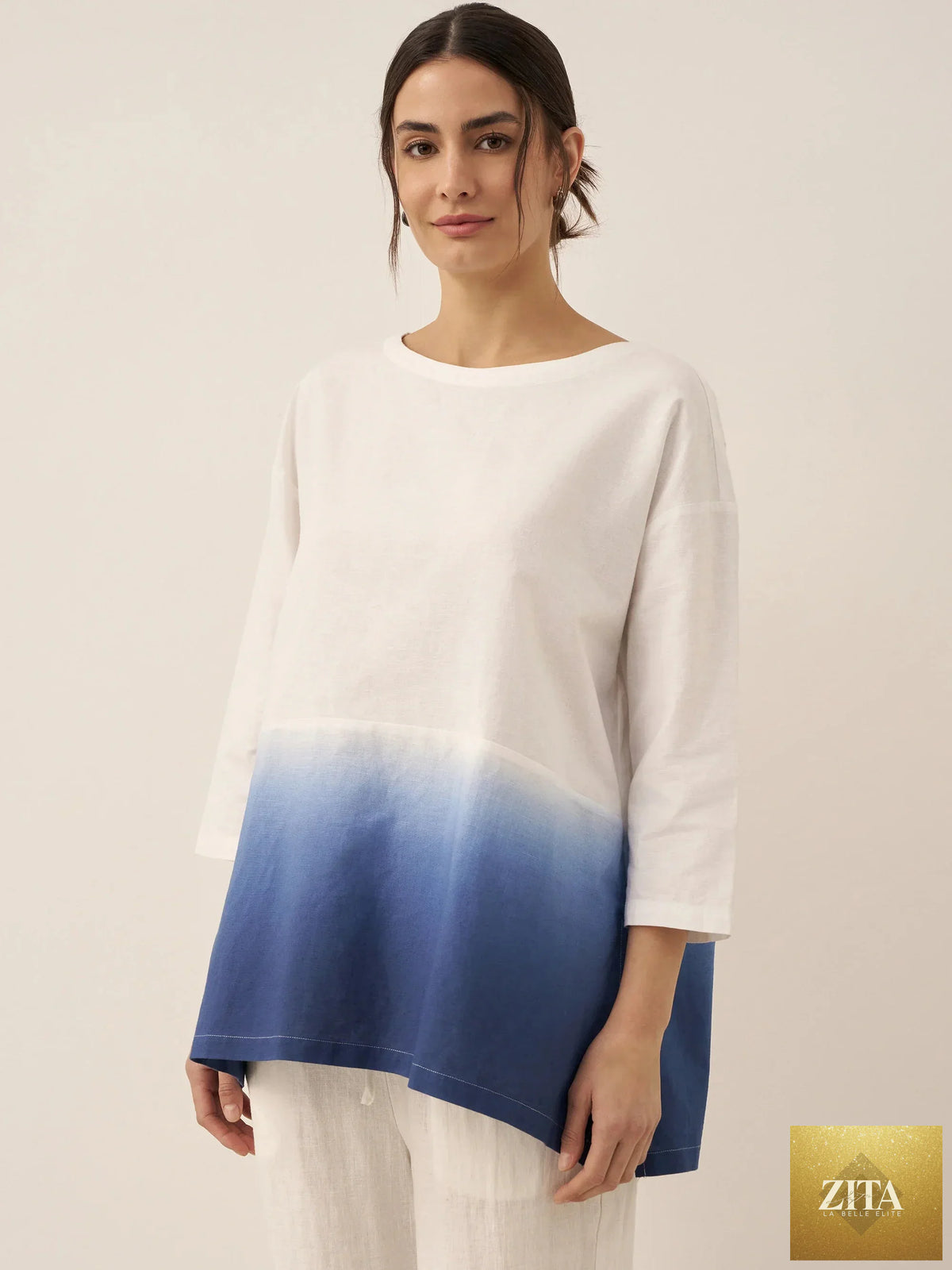 LINTICO linen white boat neck oversized top with relaxed fit, made from linen blend fabric, shown on a hanger.