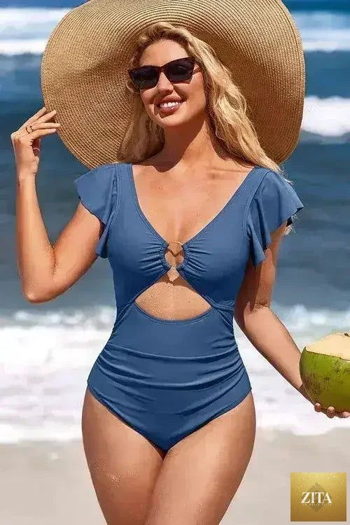 Femstylo ruffle sleeve swimsuit with O-ring cutout and tummy control, featuring stylish design and vibrant swimwear fabric.