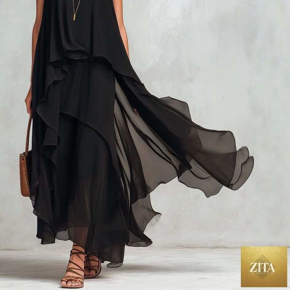 Black asymmetrical ruffle mesh chiffon sleeveless maxi dress by FitiqueFit, featuring flowing fabric and stylish design on a casualwear model.