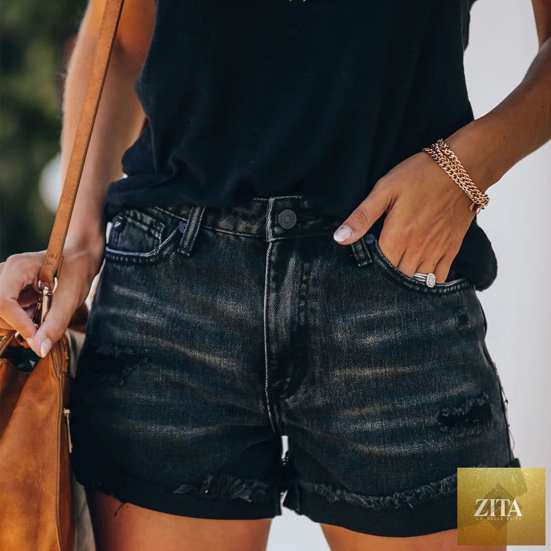 Black high waist denim hot pants with high elasticity, spring and summer fashion style, worn by a woman.