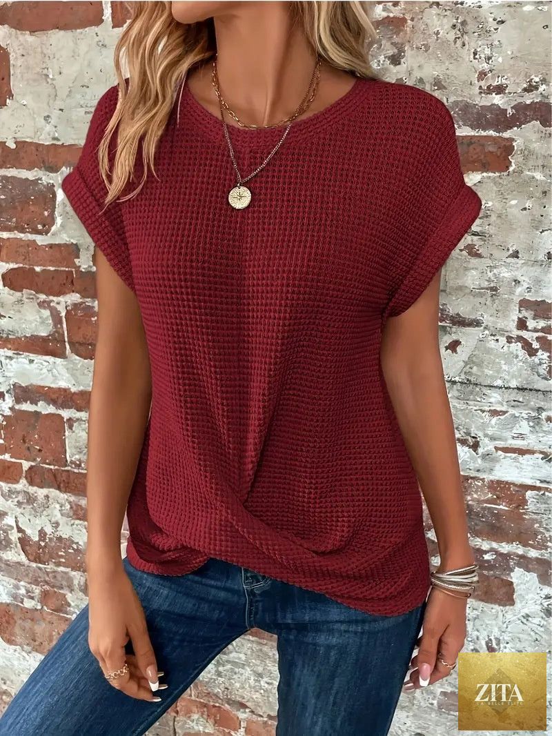 Women’s textured cuff short-sleeve tee by FitiqueFit, shown in a casualwear setting with a close-up of the short sleeves and textured fabric.