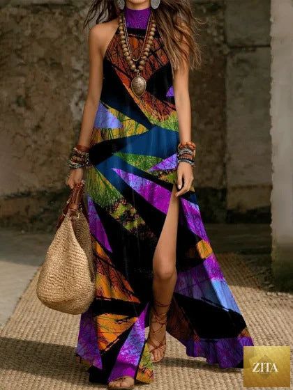 Women's printed halterneck split maxi dress by Zita La Belle Elite, sleeveless, loose fit with vibrant floral pattern and flowing fabric.