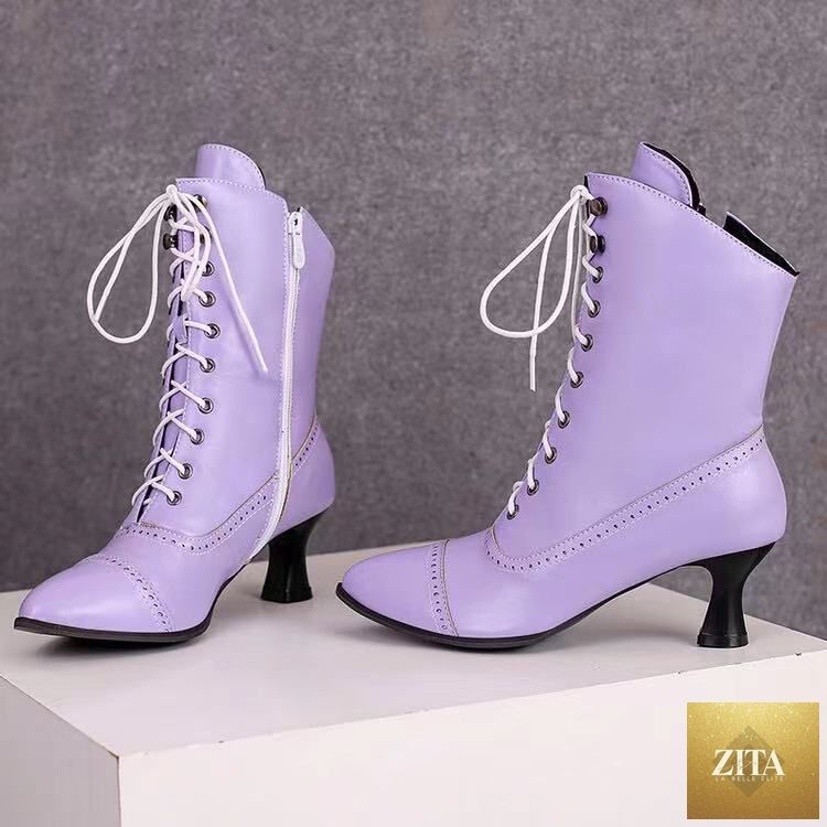 Women’s high heel Martin boots by Zita La Belle Elite featuring British motorcycle fashion style, black leather with buckle details.