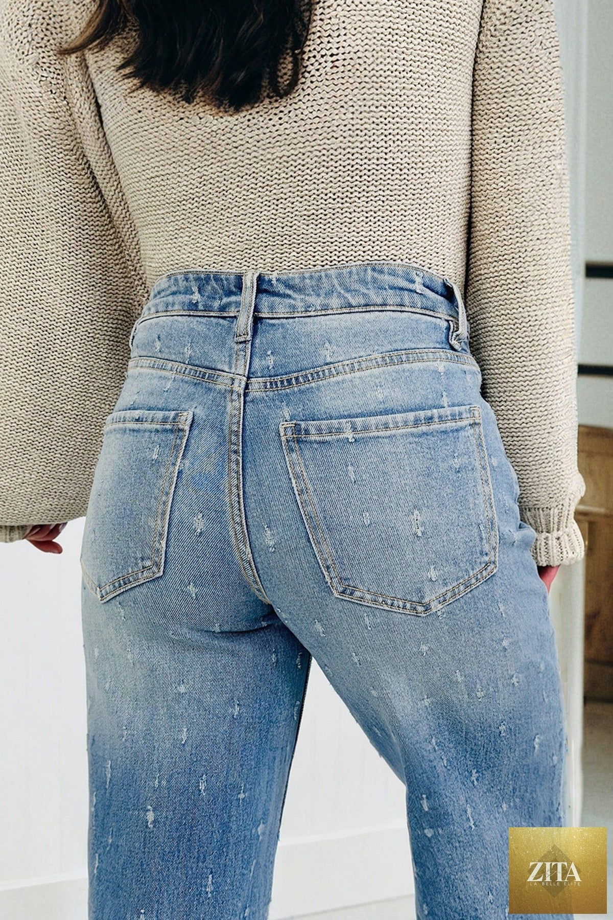 Mist Blue distressed detail tummy control jeans with raw hem from Wild and Free Boutique, featuring a fitted waist and casual style.