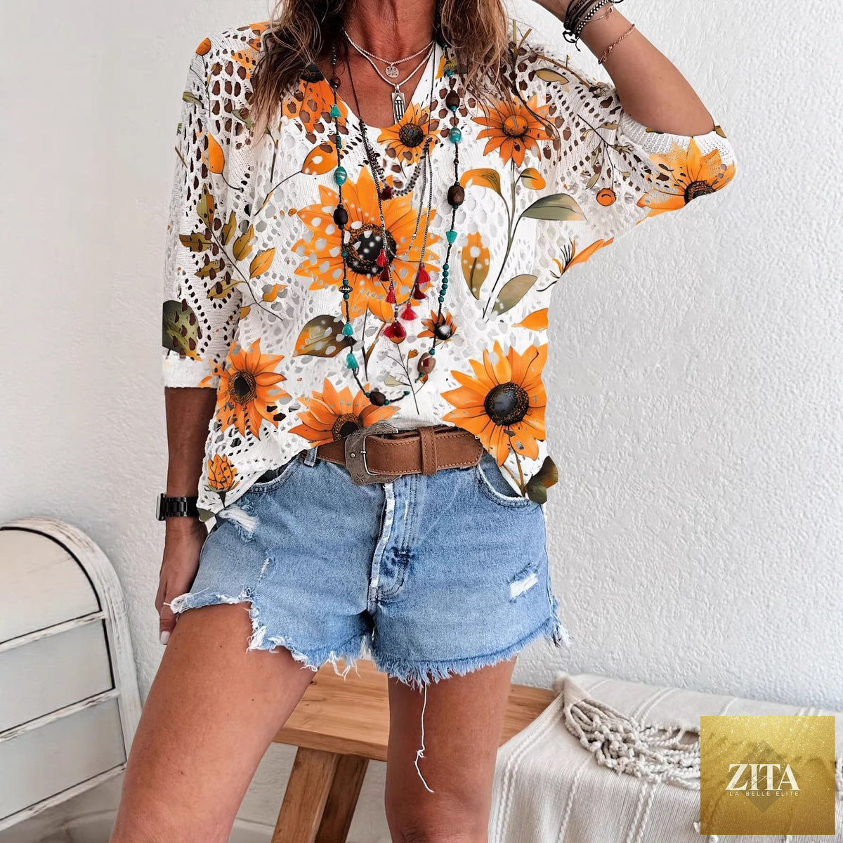Women's batwing-sleeve sweater by Zita La Belle Elite featuring hollowed-out 3D knitted print and relaxed fit, front view.