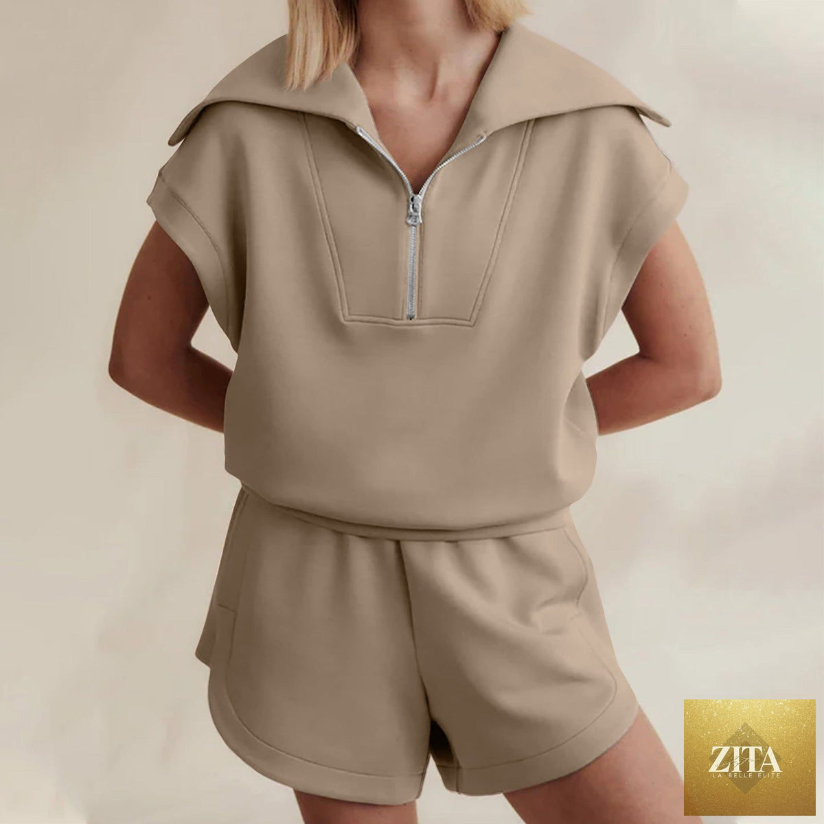 FitiqueFit two-piece set with half-zip sweatshirt and matching shorts in a casual, comfortable style, shown in a neutral color.