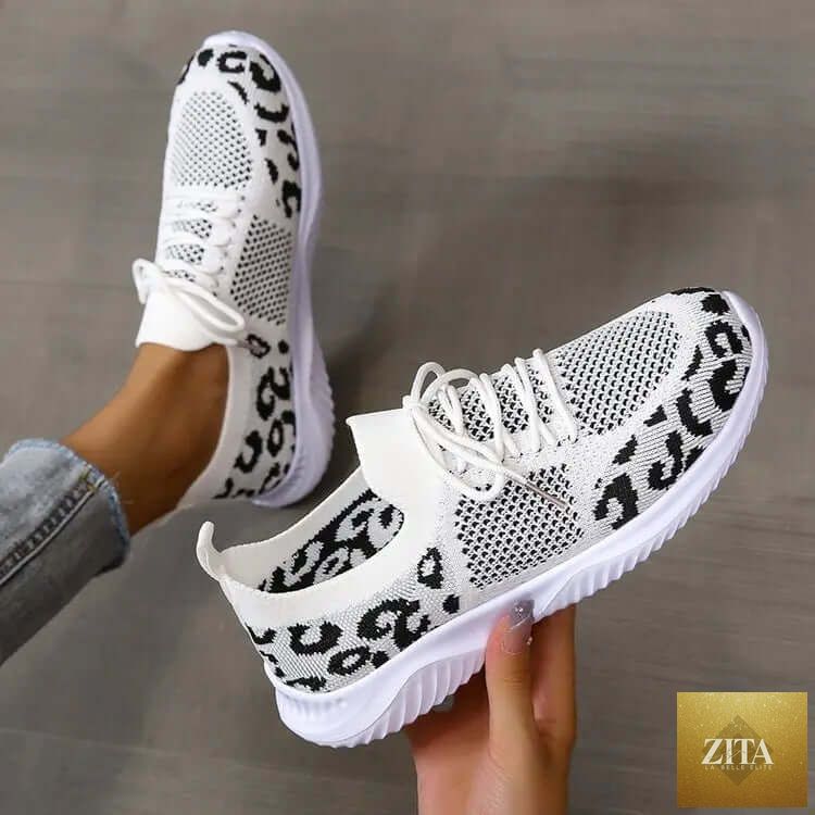 White women's sneakers with leopard print accents, lace-up design, and sporty style from SnagBag.