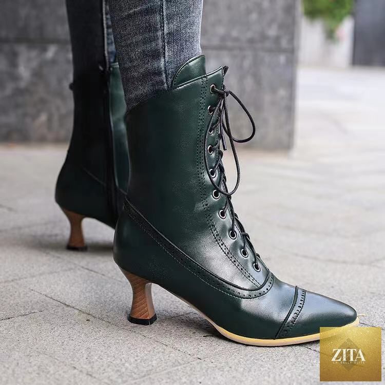 Black women’s high heel Martin boots by Zita La Belle Elite featuring British motorcycle style footwear with buckle details and sturdy heels.