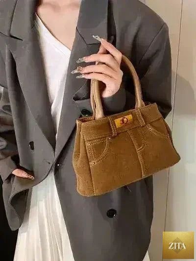 Femstylo stylish suede handbag with adjustable strap and dual-use design, featuring a sleek, compact shape and elegant details.