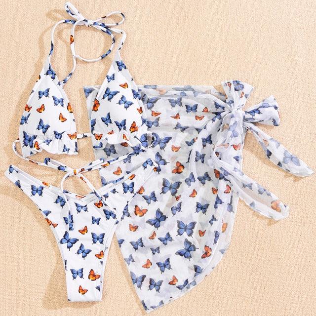 Stevvex 3-piece women's bikini set with high-cut style, halter top, wrap skirt, lace-up details, backless design, and string accents.